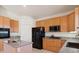 Kitchen featuring granite countertops, oak cabinets, stainless steel appliances, and a center island at 3088 Evening Mist Ave, Henderson, NV 89052
