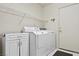 Functional laundry room equipped with modern washer and dryer, cabinet storage, and convenient shelving for organized efficiency at 3088 Evening Mist Ave, Henderson, NV 89052
