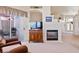 Cozy living room featuring a fireplace, television, outdoor patio access and comfortable seating at 3088 Evening Mist Ave, Henderson, NV 89052