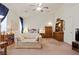 Spacious main bedroom featuring neutral colors, cozy sitting area, and ample natural light, creating a tranquil retreat at 3088 Evening Mist Ave, Henderson, NV 89052