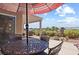 Comfortable patio featuring an outdoor table, chairs, and beautiful desert views at 3088 Evening Mist Ave, Henderson, NV 89052