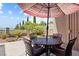 Outdoor patio with an umbrella covered table and chairs, offering a relaxing space to enjoy the view at 3088 Evening Mist Ave, Henderson, NV 89052