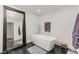 The bright bathroom features a soaking tub, modern fixtures, and an oversized mirror at 3108 Sonia Dr, Las Vegas, NV 89107