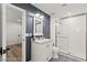 Well-lit bathroom with white vanity, marble countertop, and a tiled glass shower at 3108 Sonia Dr, Las Vegas, NV 89107