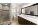 Modern bathroom with a glass-enclosed shower, dark wood vanity, and ample counter space at 3108 Sonia Dr, Las Vegas, NV 89107