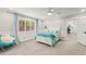 Bright bedroom with a white bed frame, plush carpet, and a ceiling fan at 3108 Sonia Dr, Las Vegas, NV 89107
