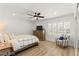 Bedroom with a cozy armchair, natural wood flooring and shutters over the windows at 3108 Sonia Dr, Las Vegas, NV 89107