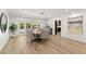 Bright dining room with wood floors features a modern table with seating for eight guests at 3108 Sonia Dr, Las Vegas, NV 89107