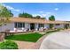 Charming home featuring a well-manicured front yard with lush lawn, seating, and inviting curb appeal at 3108 Sonia Dr, Las Vegas, NV 89107