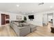 Comfortable living room with a large sectional sofa, wooden floors, and a modern entertainment setup at 3108 Sonia Dr, Las Vegas, NV 89107