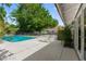 Backyard featuring a pool, shaded seating, and landscaped greenery, perfect for outdoor entertaining and relaxation at 3108 Sonia Dr, Las Vegas, NV 89107