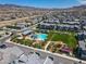 Aerial view of the community pool, park, and playground amidst modern residential houses at 3219 Timorasso Ave, Henderson, NV 89044