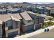 Aerial view of a modern townhome complex with a mountain backdrop at 3219 Timorasso Ave, Henderson, NV 89044