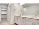 A sleek bathroom offers double sinks with white counters and a view of a walk-in closet at 3219 Timorasso Ave, Henderson, NV 89044