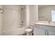 Charming bathroom showcases a shower-tub combo and sleek white vanity at 3219 Timorasso Ave, Henderson, NV 89044