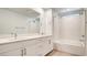Bright bathroom boasts double sinks with white countertops, a large mirror, and a shower-tub combo at 3219 Timorasso Ave, Henderson, NV 89044