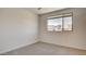 This bedroom offers plush carpet and a large window, flooding the space with natural light at 3219 Timorasso Ave, Henderson, NV 89044