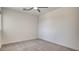Carpeted bedroom featuring white walls, a ceiling fan, and natural light at 3219 Timorasso Ave, Henderson, NV 89044