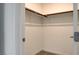 Walk-in closet with wooden clothing racks at 3219 Timorasso Ave, Henderson, NV 89044
