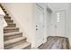Entryway featuring new carpeted stairs, wood floors, and modern doors at 3219 Timorasso Ave, Henderson, NV 89044