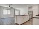 Bright kitchen featuring an island, stainless steel appliances, and wood floors at 3219 Timorasso Ave, Henderson, NV 89044