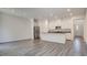 Open-concept living space with modern kitchen, stainless appliances, and wood floors at 3219 Timorasso Ave, Henderson, NV 89044