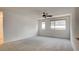 Spacious bedroom with neutral carpet, ceiling fan, and bright natural light at 3219 Timorasso Ave, Henderson, NV 89044