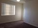 Simple bedroom with neutral walls, carpet flooring, and a window for natural light at 3318 N Decatur Blvd # 2077, Las Vegas, NV 89130