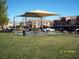 Community picnic tables and covering for shade within manicured landscaping at 3318 N Decatur Blvd # 2077, Las Vegas, NV 89130