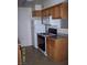 Efficient kitchen featuring wood cabinets, black appliances, and a white refrigerator at 3318 N Decatur Blvd # 2077, Las Vegas, NV 89130