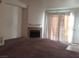 Cozy living room with fireplace and natural light from sliding glass doors at 3318 N Decatur Blvd # 2077, Las Vegas, NV 89130