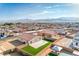 High aerial view of a backyard with artificial turf in a single Gathering home near desert mountains at 3665 E Garfield Dr, Pahrump, NV 89061