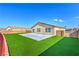 The backyard has a concrete patio and artificial grass at 3665 E Garfield Dr, Pahrump, NV 89061