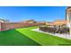 Fully fenced backyard offers artificial grass, seating area and unobstructed views at 3665 E Garfield Dr, Pahrump, NV 89061