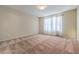 Bright bedroom with neutral walls, carpet, and large window providing plenty of natural light at 3665 E Garfield Dr, Pahrump, NV 89061