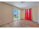 Bedroom with hardwood floors with a sliding glass door to backyard and view of red curtains at 3665 E Garfield Dr, Pahrump, NV 89061