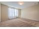 Large bedroom with soft carpet, neutral walls, and a bright window at 3665 E Garfield Dr, Pahrump, NV 89061