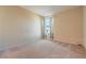 Cozy bedroom with neutral walls, plush carpet, and a window with patterned curtains at 3665 E Garfield Dr, Pahrump, NV 89061