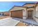 Single-story home featuring an attached two car garage, desert landscaping, and covered front entryway at 3665 E Garfield Dr, Pahrump, NV 89061