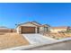 Charming single story home with a two car garage, low maintenance desert landscaping, and desert skies at 3665 E Garfield Dr, Pahrump, NV 89061