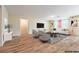 Living room features modern furniture, wood-look tile flooring and recessed lighting at 3665 E Garfield Dr, Pahrump, NV 89061