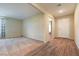 Inviting living room with wood-look tile flooring transitioning to plush patterned carpeting at 3665 E Garfield Dr, Pahrump, NV 89061