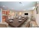 Open concept living room with a dining area and kitchen with hardwood floors and neutral paint at 3665 E Garfield Dr, Pahrump, NV 89061