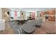 Staged living room with an open floorplan with kitchen and dining area, hardwood floors, and neutral paint at 3665 E Garfield Dr, Pahrump, NV 89061