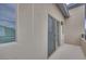 Balcony with neutral stucco walls, a window, sliding glass door and black metal railing at 4333 Tabor Peak Ave, Las Vegas, NV 89141