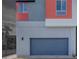 Modern home featuring a gray garage door and red siding accents at 4333 Tabor Peak Ave, Las Vegas, NV 89141