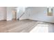 Bright living room with wood floors, white walls, and a staircase, modern design at 4333 Tabor Peak Ave, Las Vegas, NV 89141