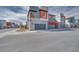 Modern home exterior featuring gray and red accents, with a paved street in front at 4333 Tabor Peak Ave, Las Vegas, NV 89141