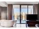 Modern bathroom featuring a soaking tub, a large window and sliding door with a city view at 4381 W Flamingo Rd # 3002, Las Vegas, NV 89103