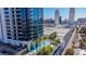 Exterior of the modern building with pool, palm trees, city views and multiple lounging chairs at 4381 W Flamingo Rd # 3002, Las Vegas, NV 89103